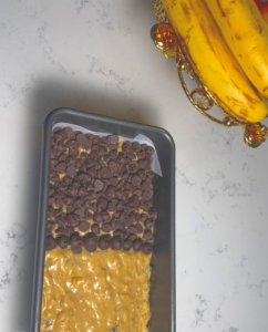 transfer the batter into the mold and decorate with chocolate ships and Crushed Pistachio