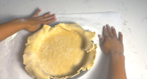 roll out the dough and put in the the mold, cut out the excess dough around the edges