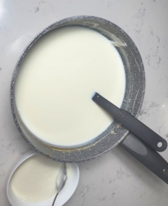 take a cup of heated mill in a bowl and add the yogurt starter and mix welled before putting it back in the pot