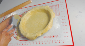 Trim the excess dough around the pir pan