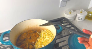 cook the onion one side and brown the chicken on the other side, then take the chicken out to rest on a plate.
