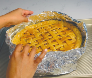 Use Aluminum Foil to cover around the rim during the baking time