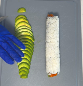 decorate top of the roll with slice avocados