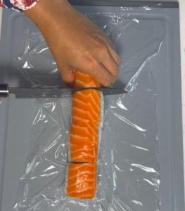 Put plastic wrap over the roll before cutting, make it less messy, nicer to cut