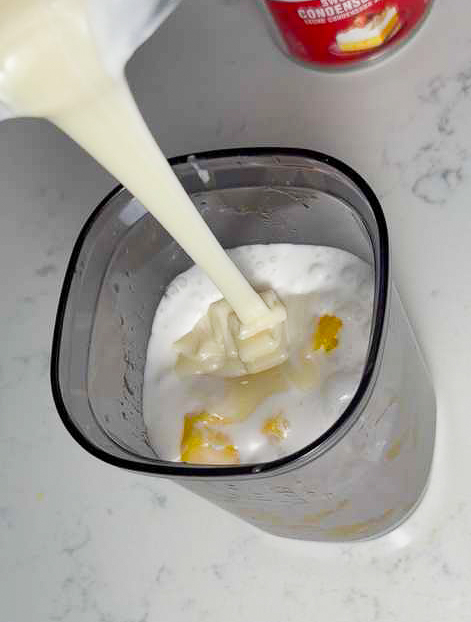 Add coconut milk, sweeten condensed milk, mango and blend it up